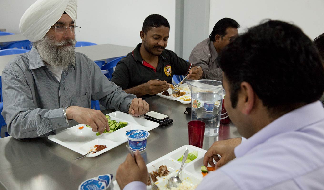 Labour camp staff eating by Newrest Gulf in Qatar